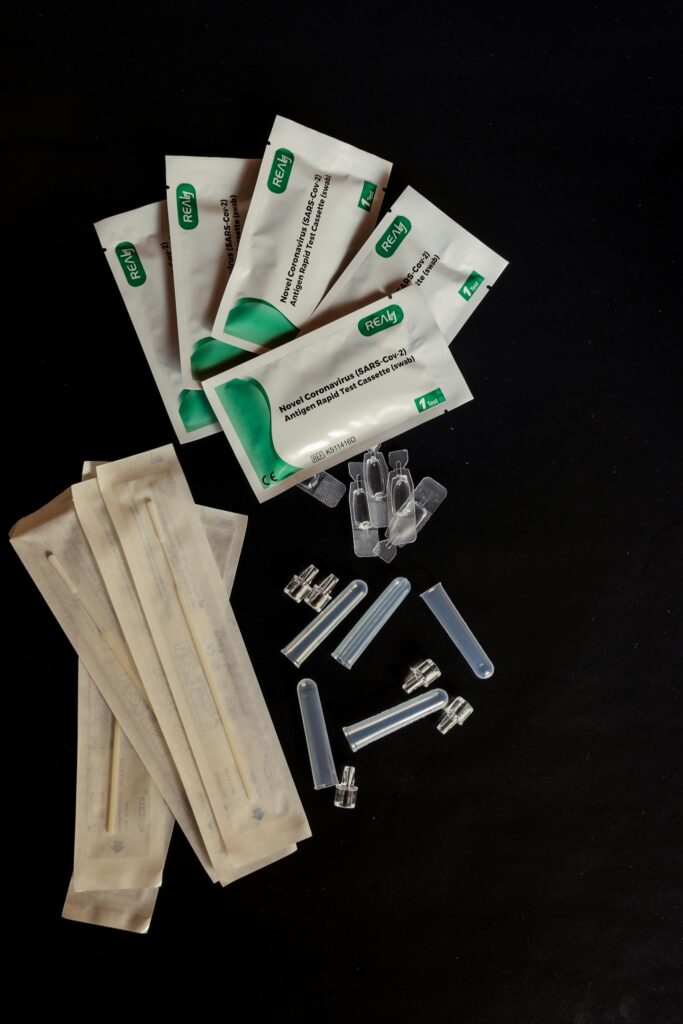 Close-up of sterilized medical equipment and packaging on a black background.